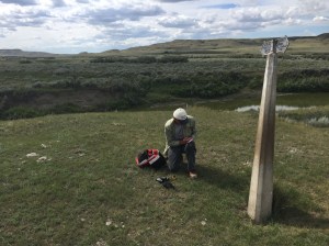 Hugh kneeling before marker