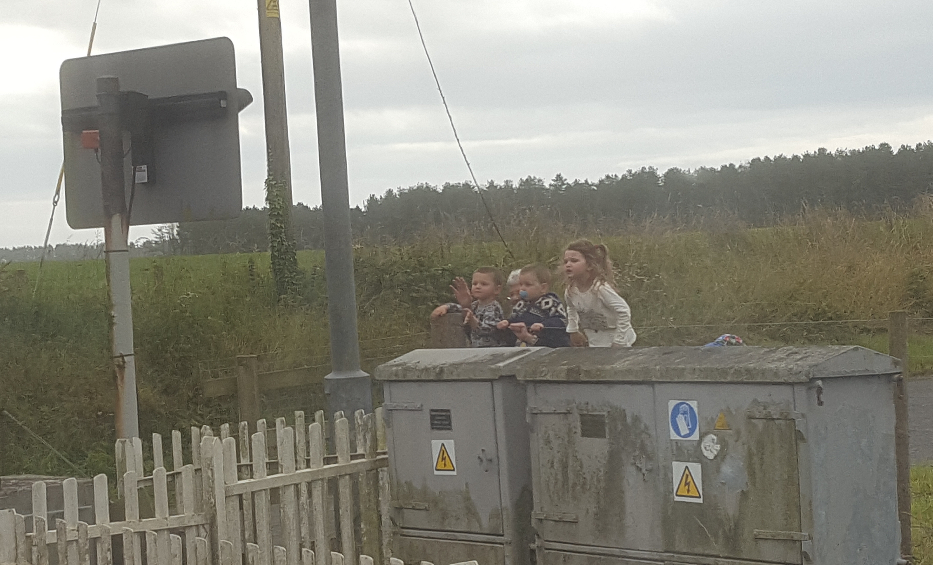 kids waving at the train